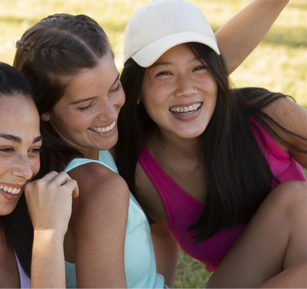 Group of young friends outside smiling with ceramic braces