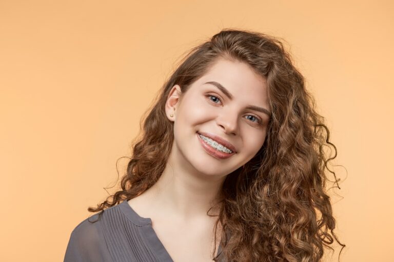Adult patient with braces smiling, Premiere Orthodontics in Orlando, FL